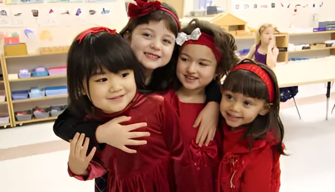 3 Four girls in red dresses smiling together.