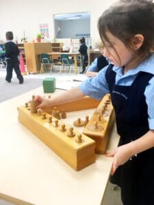 Child engaging with Montessori learning materials.