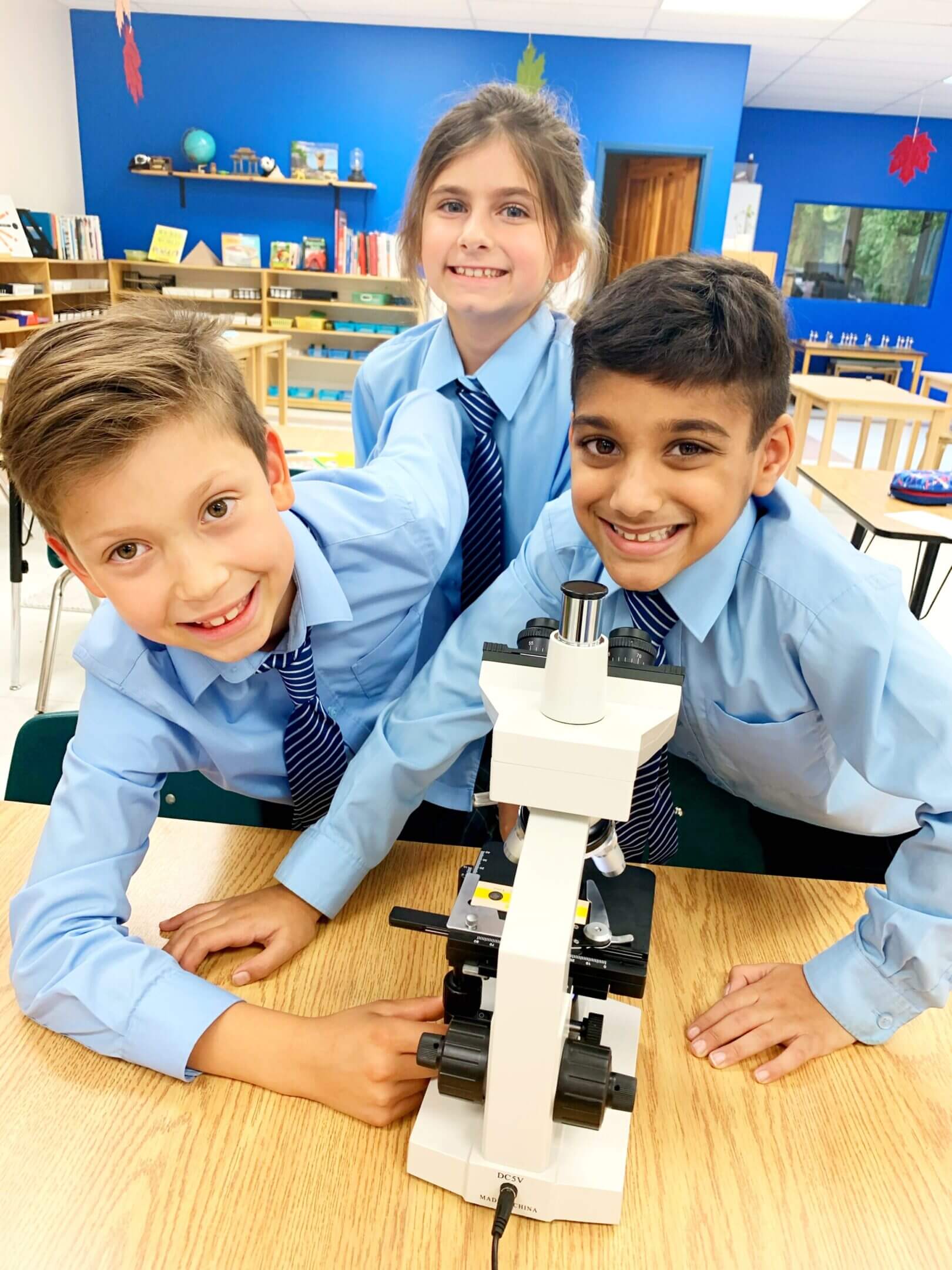 Children exploring with a microscope in class.