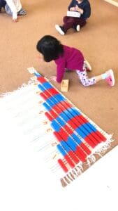 Children playing with colorful counting blocks.