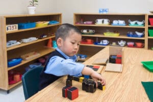 Child playing with colorful building blocks.