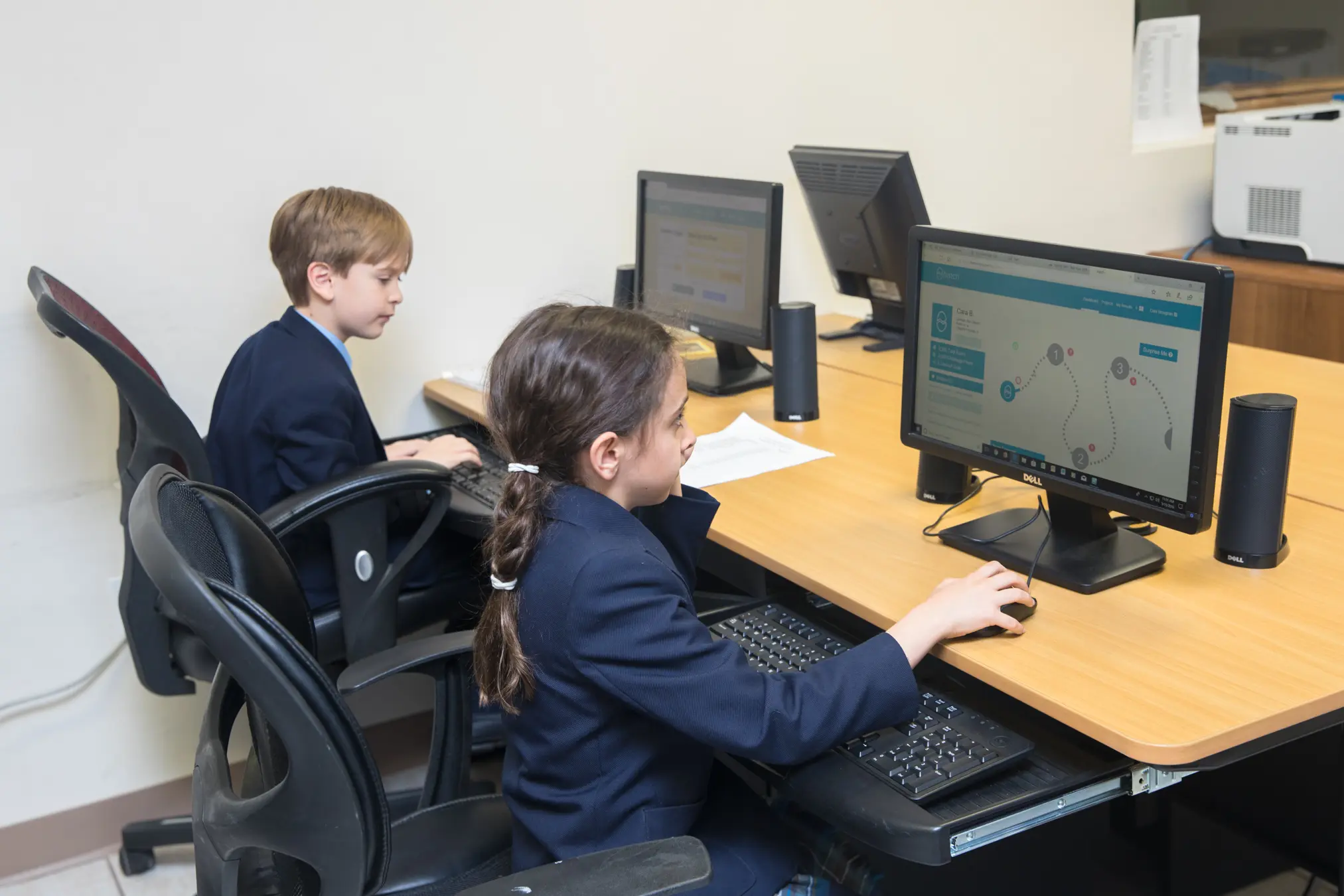 Children working on computers in classroom.