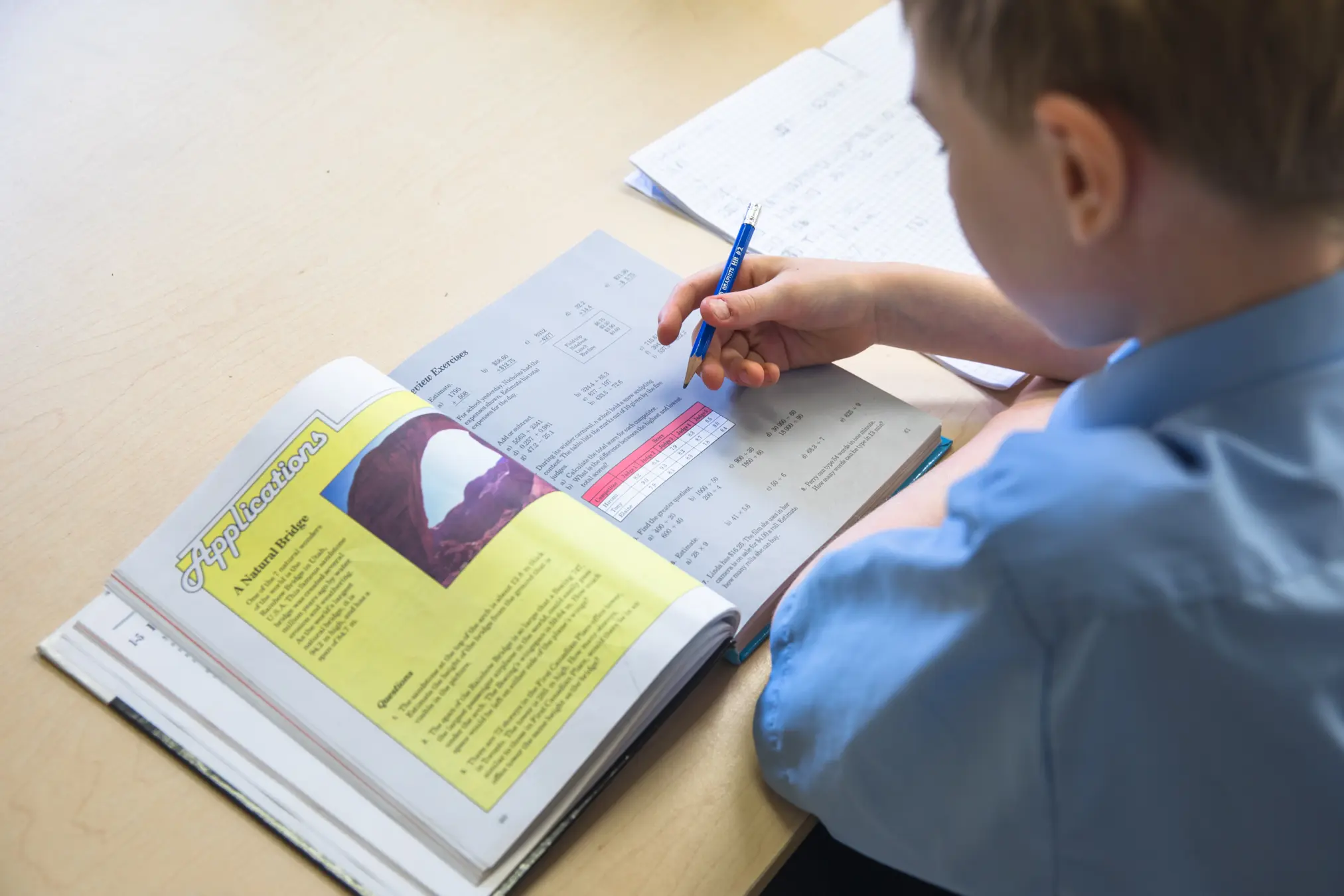 Student working on homework in classroom.