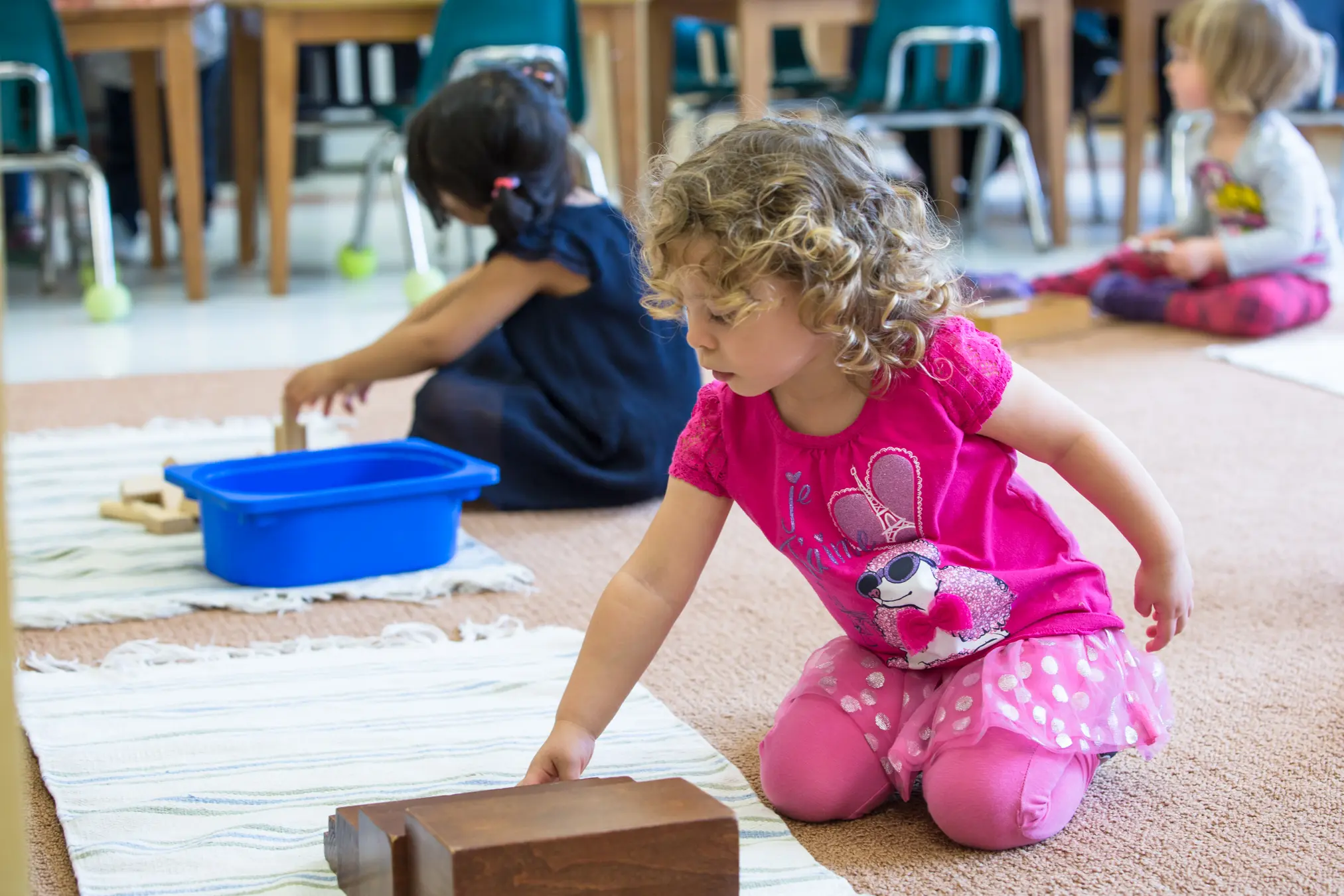 Children playing with blocks in classroom.