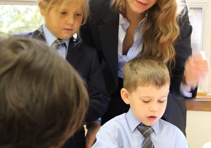 Children and teacher engaging in classroom activity.